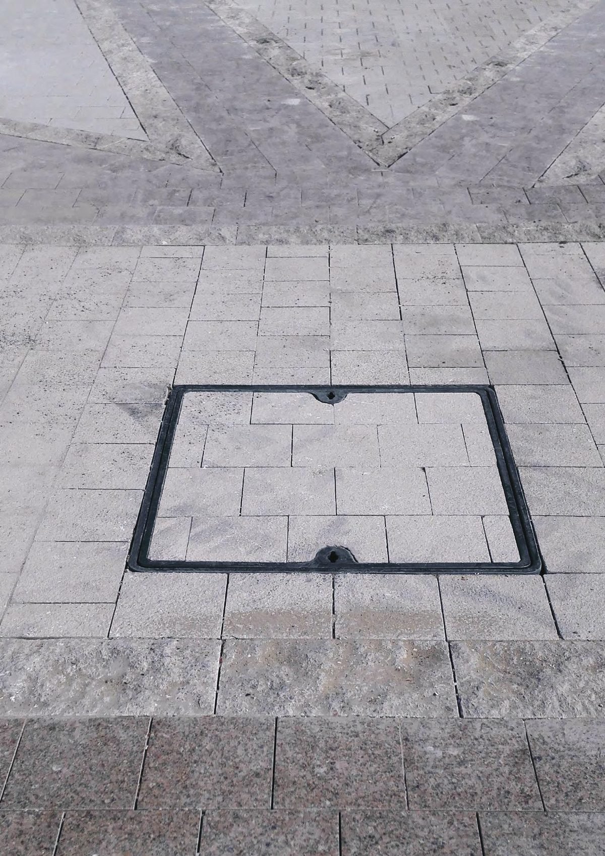 Recessed cover filled with the surrounding block paving